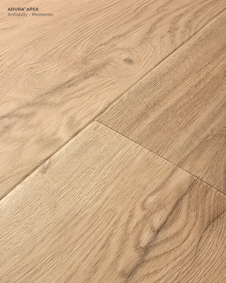 Close-up of Antiquity in Memento, pale warm oak-look planks with small knots