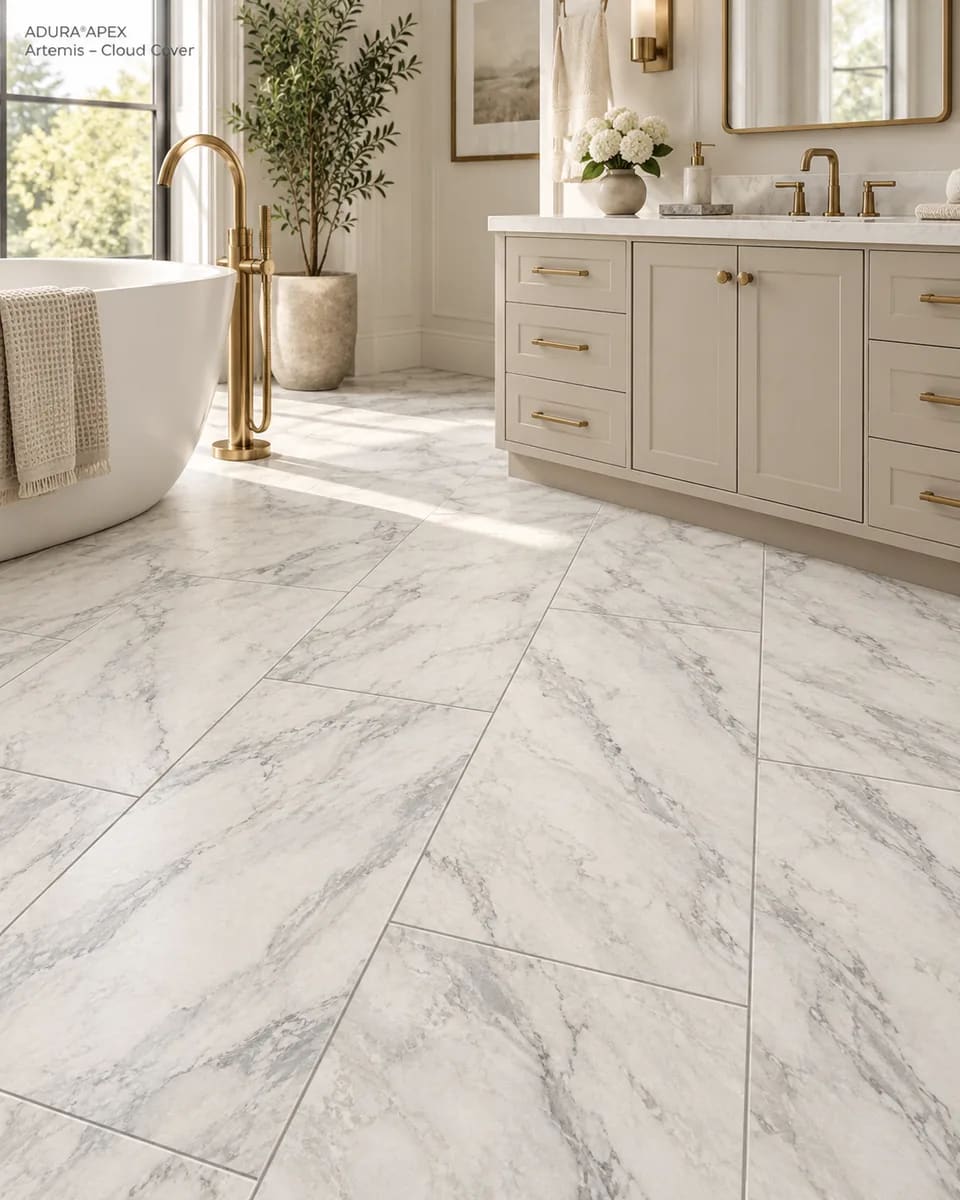 Bathroom with a freestanding tub and a grey vanity on large white marble-look Artemis tiles