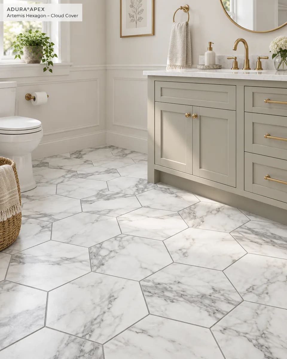 Bathroom with a sage vanity and brass fixtures on a white marble-look hexagon tile floor